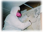 A remediation worker with necessary protection gear during a mold remediation.